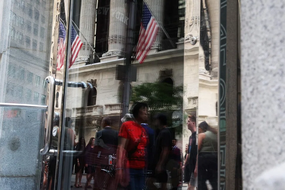 People walk by the New York Stock Exchange (NYSE) on 2 August 2023 in New York City, US. (Spencer Platt/Getty Images/AFP)