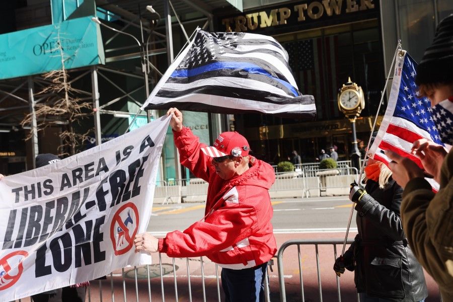 A small group of supporters of former president Donald Trump hold a rally in front of Trump Tower on 8 March 2021 in New York City. (Spencer Platt/AFP)