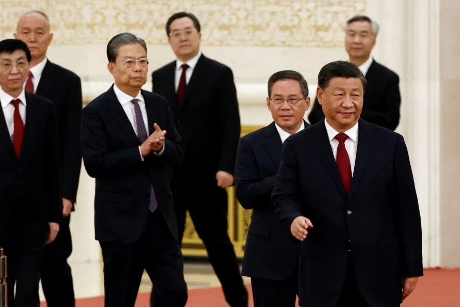 New Politburo Standing Committee members Xi Jinping, Li Qiang, Zhao Leji, Wang Huning, Cai Qi, Ding Xuexiang and Li Xi arrive to meet the media following the 20th National Congress of the Communist Party of China, at the Great Hall of the People in Beijing, China 23 October 2022. (Tingshu Wang/Reuters)
