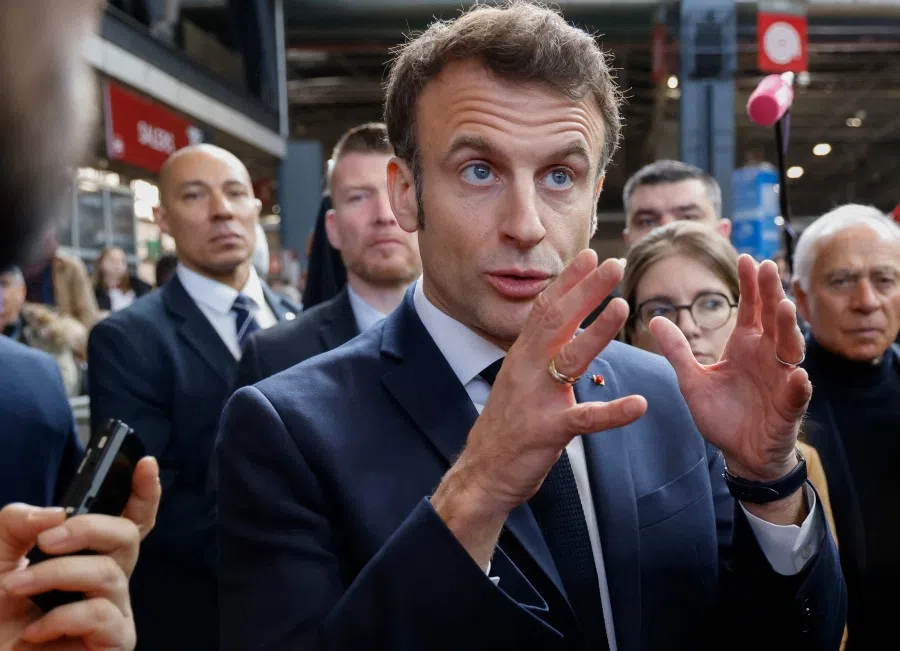 France's President Emmanuel Macron (centre), speaks to media on the sidelines of the 59th edition of the International Agriculture Fair on its inauguration day in Paris on 25 February 2023. (Ludovic Marin/AFP)
