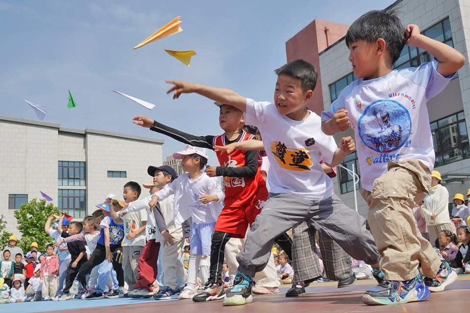Children fly paper airplanes at the Second Experimental Kindergarten in Yantai High-tech Zone, Shandong province, China, on 29 May 2024. (CFOTO/Sipa USA via Reuters)