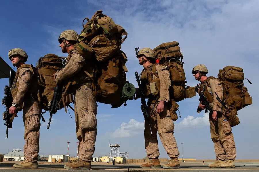 In this file photo taken on 27 October 2014, US Marines board a C-130J Super Hercules transport aircraft headed to Kandahar as British and US forces withdraw from the Camp Bastion-Leatherneck complex at Lashkar Gah in Helmand province, Afghanistan. (Wakil Kohsar/AFP)