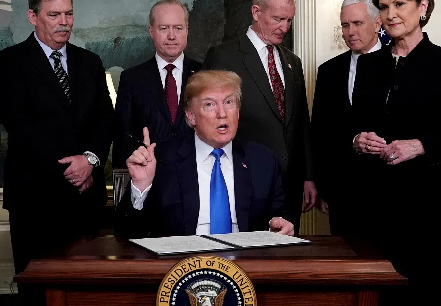 US President-elect Donald Trump, prepares to sign a memorandum on tariffs on high-tech goods from China, at the White House in Washington D.C. on 22 March 2018, during his first term as president. (Jonathan Ernst/Reuters)