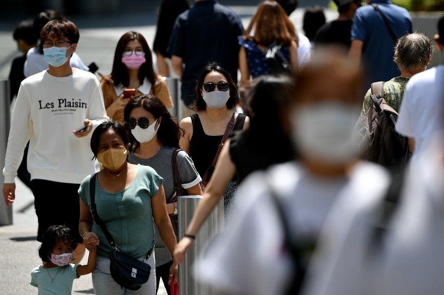 People wearing face masks walk at Orchard Road, in Singapore, on 10 August 2021. (SPH Media)