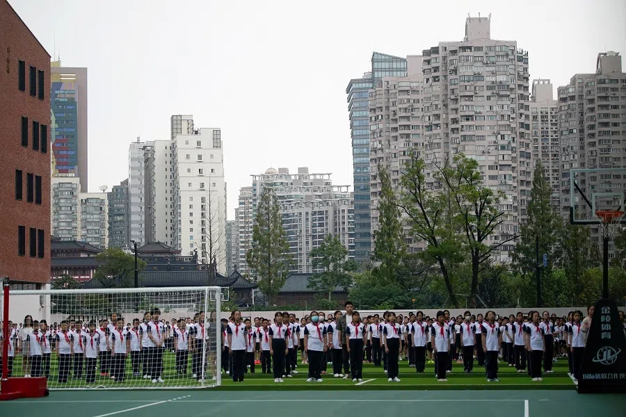 Students stand at a school on the first day of the new academic year in Shanghai, China, on 1 September 2021. (Aly Song/Reuters)