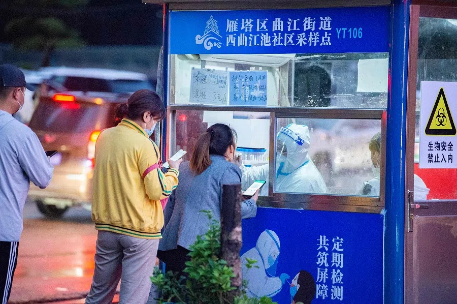 This photo taken on 29 August 2022 shows a health worker taking a swab sample from a resident to be tested for Covid-19 in Xi'an, Shaanxi province, China. (AFP)