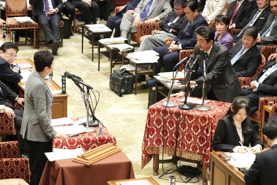 Japan's Prime Minister Shinzo Abe (right) attends a parliament session in Tokyo on 3 February 2020. Abe will work with international health officials as Tokyo continues to prepare for the summer Olympics amid an international coronavirus outbreak. (STR/Jiji Press/AFP)