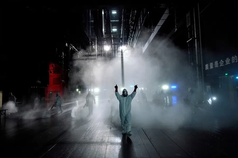 In this file photo, volunteers from the Blue Sky Rescue team disinfect at the Qintai Grand Theatre in Wuhan, Hubei province, China, 2 April 2020. (Aly Song/File Photo/Reuters)