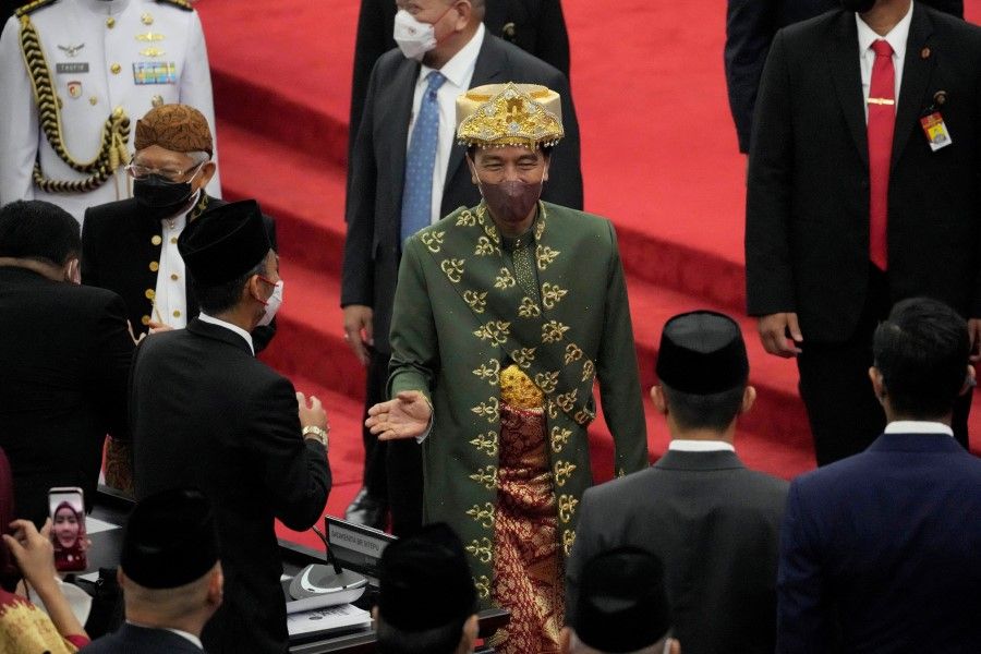 Indonesian President Joko Widodo, wearing traditional Bangka Belitung outfit, greets parliament members after delivering his annual State of the Nation Address ahead of the country's Independence Day, at the parliament building in Jakarta, Indonesia, 16 August 2022. (Tatan Syuflana/Reuters)
