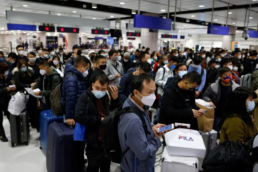 Travellers wait for the gate to open at Hong Kong's Lok Ma Chau border checkpoint on the first day China reopens the border amid the Covid-19 pandemic in Hong Kong, China, 8 January 2023. (Tyrone Siu/Reuters)