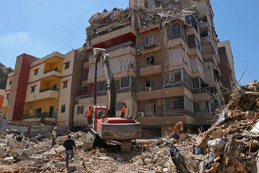 First responders inspect the rubble of a collapsed building following an Israeli airstrike a day earlier in Beirut’s southern suburb of Haret Hreik on 7 May 2026. (AFP)