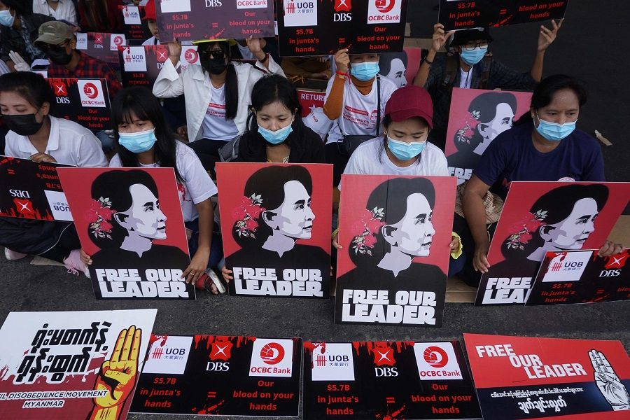 Protesters hold signs of detained Myanmar civilian leader Aung San Suu Kyi during a demonstration against the military coup in Yangon, Myanmar, on 26 February 2021. (Sai Aung Main/AFP)