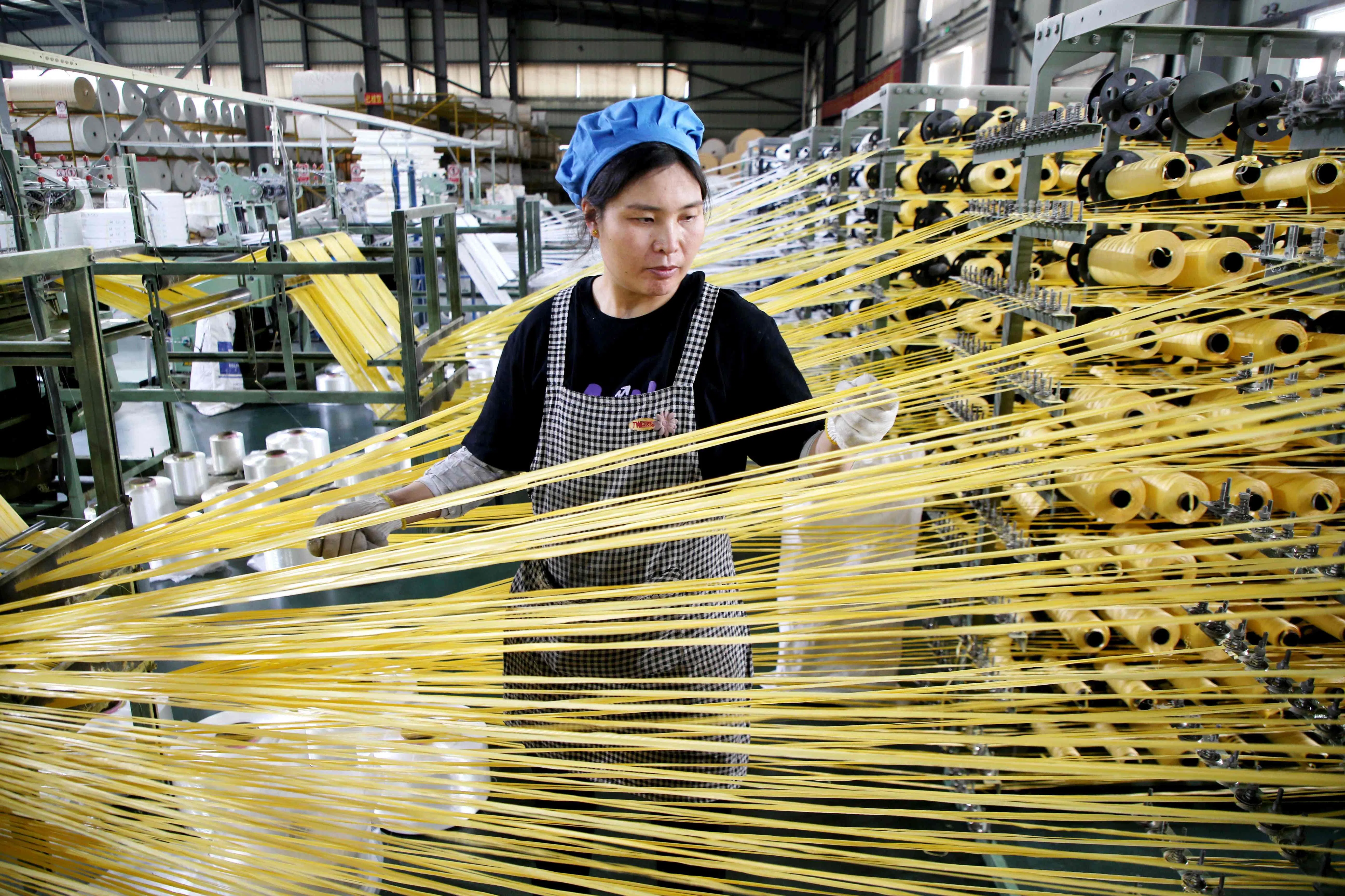 A worker monitors products for export at a packaging factory in Lianyungang, Jiangsu province, China, on 18 May 2026.