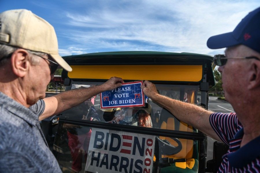 In this file photo taken on 21 August 2020, elderly people in Florida take part in a golf cart parade to celebrate the nomination of Joe Biden for Democratic presidential candidate and Kamala Harris for vice president. (Chandan Khanna/AFP)