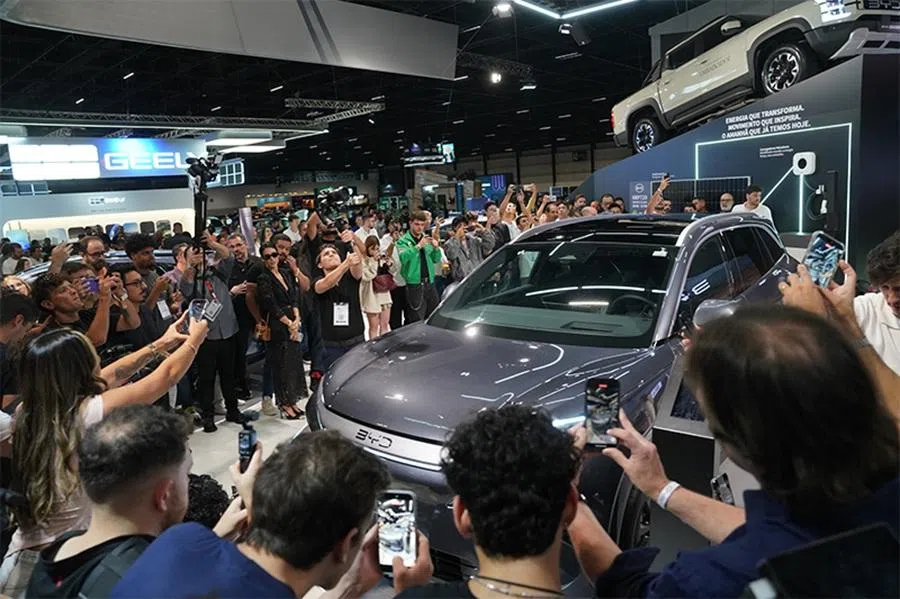 Journalists crowd around BYD’s new model at the 31st São Paulo International Motor Show on 24 November 2025. (Zhang Ruixue/Caixin)