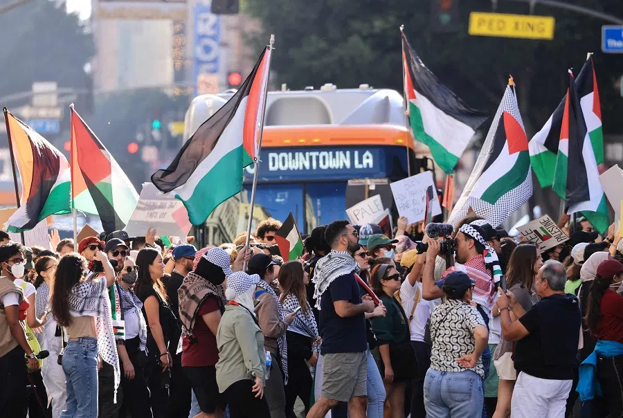 People carry banners and flags in support of the Palestinian people as thousands march through downtown Los Angeles, US, on 28 October 2023. (David Swanson/AFP)