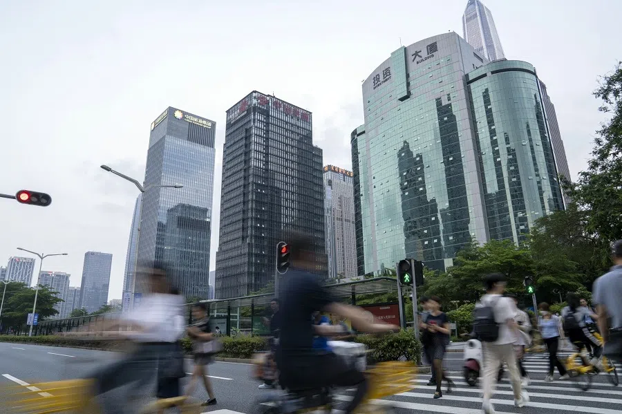 Pedestrians cross a road in Shenzhen, China on 7 May 2024.