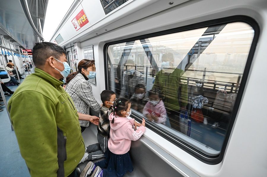Passengers looking out the window as they pass the Hongyancun Bridge, on 30 November 2023. (CNS)