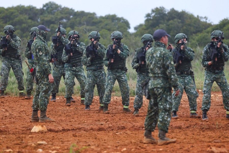 Taiwanese soldiers train at a target shooting practice in Hsinchu, Taiwan, 25 March 2022. (Ann Wang/Reuters)