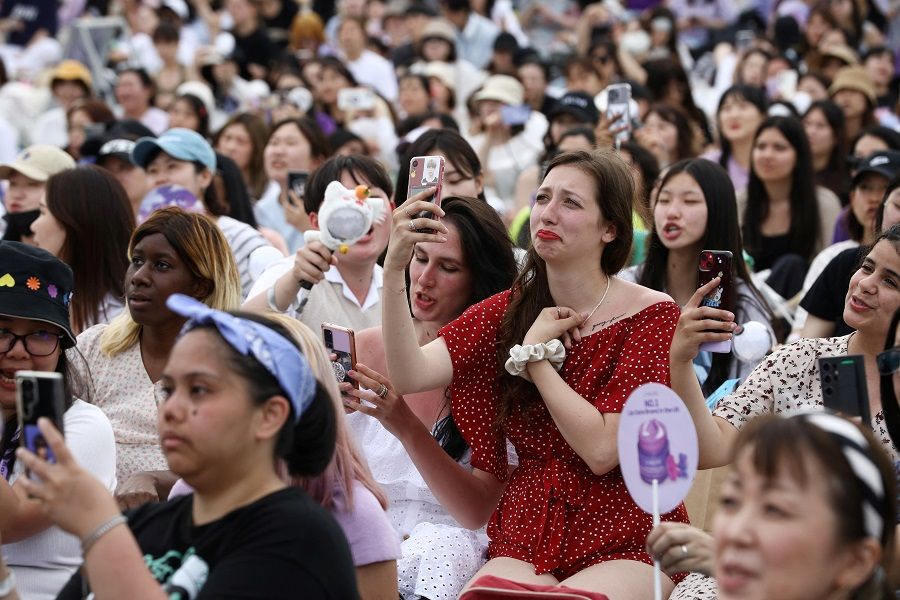 Fans of K-pop boy band BTS listen to the BTS member RM's radio show during the BTS 10th Anniversary FESTA in Seoul, South Korea, 17 June 2023. (Kim Soo-hyeon/Reuters)