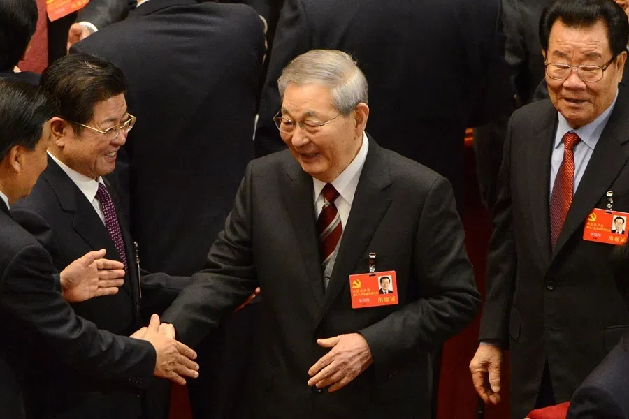 China's former Premier Zhu Rongji (centre) shakes hands with a delegate at the opening of the 18th Communist Party Congress at the Great Hall of the People in Beijing on 8 November 2012.