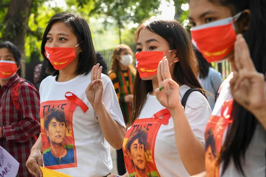 Myanmar refugees hold three-finger salutes during a demonstration in New Delhi, India on 5 February 2021, to protest against the military coup in their country. (Prakash Singh/AFP)