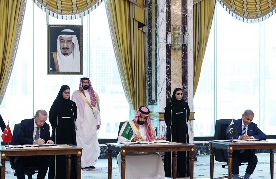 This handout photograph released by the Turkish Presidency press office on 7 August 2026, shows Saudi Arabia's Crown Prince Mohammed bin Salman, flanked by Turkey's President Recep Tayyip Erdoğan (L) and Pakistan’s Prime Minister Shehbaz Sharif, signing a joint defence agreement in Mecca.