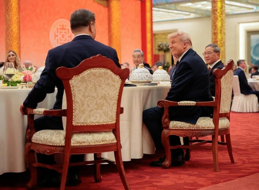 US President Donald Trump reacts next to Chinese President Xi Jinping at a state banquet at the Great Hall of the People in Beijing, China, on 14 May 2026.