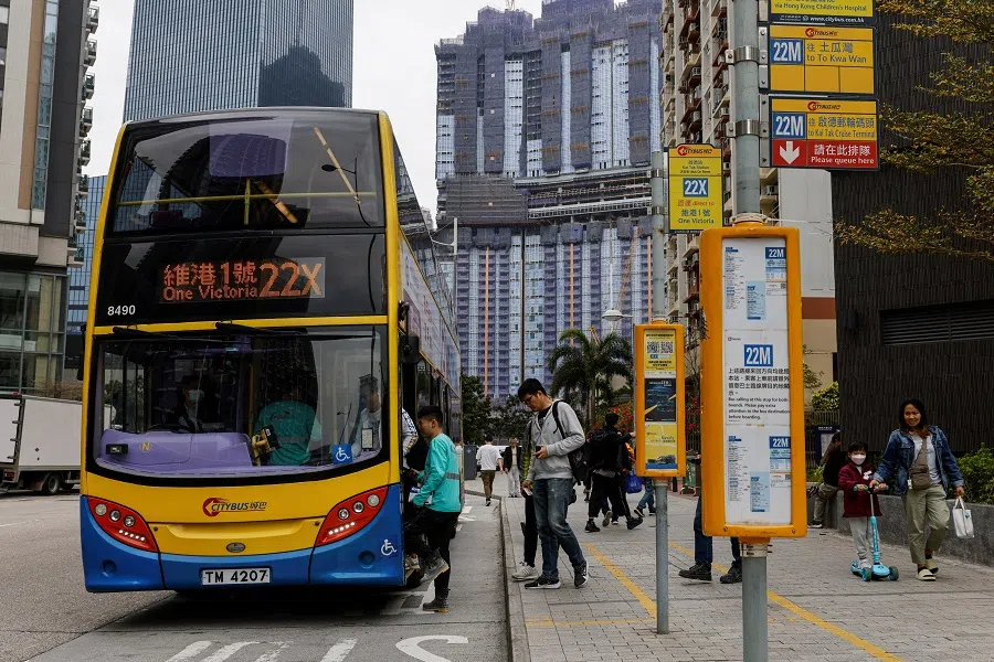 People queue to board a double-decker bus in Hong Kong, China, on 27 February 2024. (Tyrone Siu/Reuters)