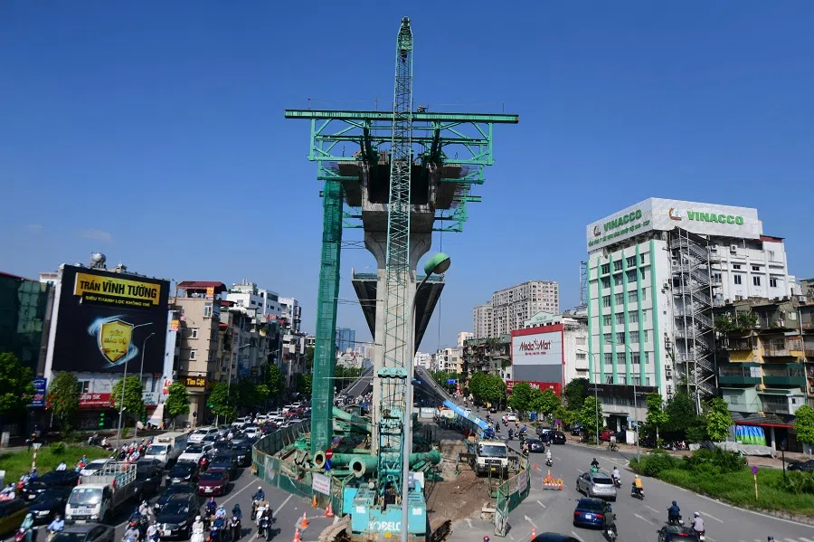 Commuters travel past an under-construction bridge in Hanoi, Vietnam, on 5 October 2021. (Nhac Nguyen/AFP)