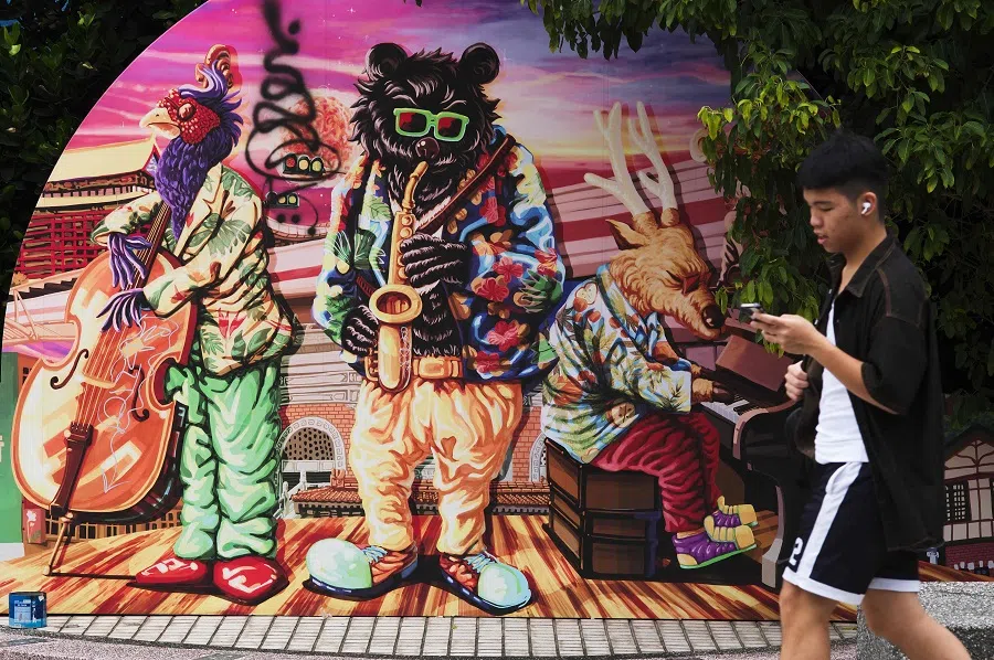 A man walks past a mural painting in Taipei on 6 August 2024. (Sam Yeh/AFP)