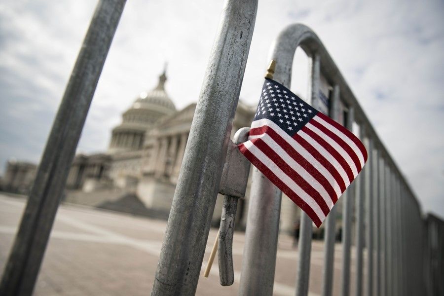 An American flag is placed on a fence outside of the US Capitol building on 28 September 2020 in Washington, DC. (Al Drago/AFP)