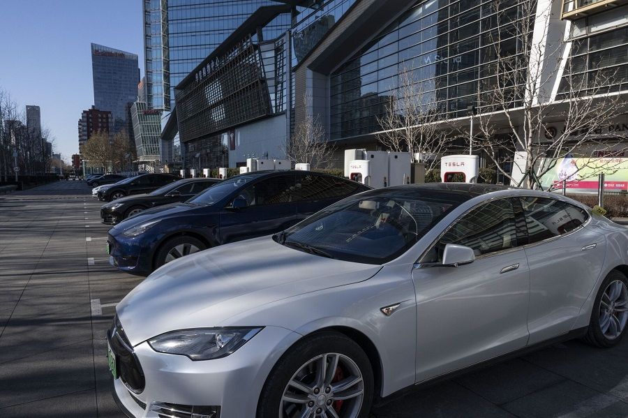 Tesla electric vehicles parked at charging stations in the central business district of Beijing, China, on 6 January 2024. (Bloomberg)
