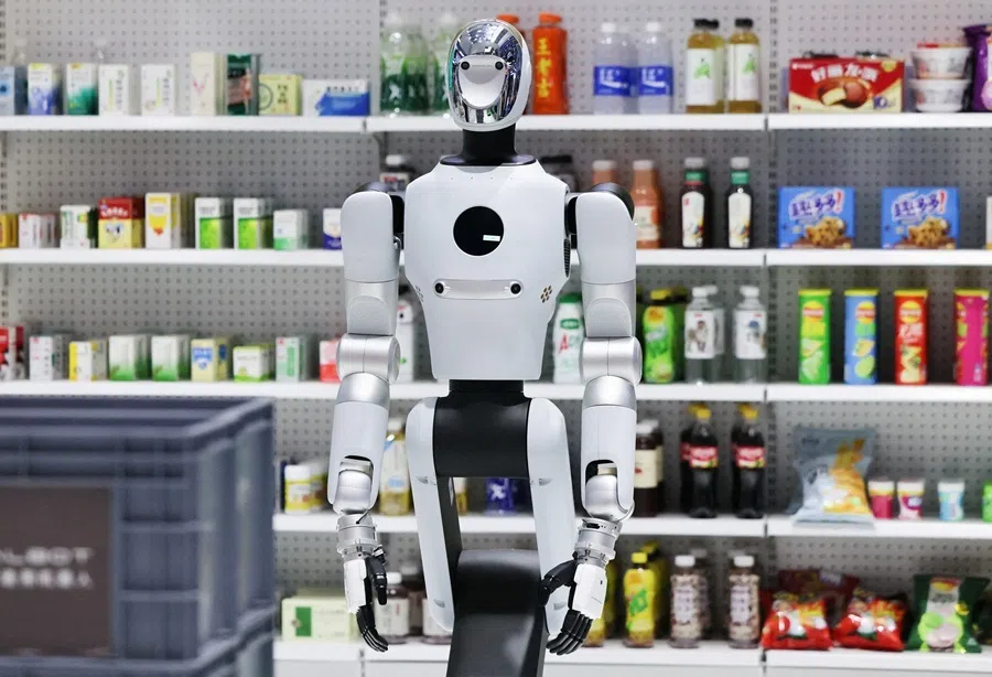 A Galbot G1 robot displayed next to shelves with goods at the company's booth at the 2026 World Robot Conference, in Beijing, China, on 20 August 2026.