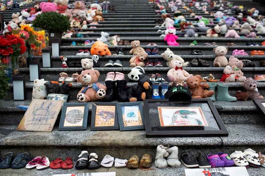 Teddy bears, shoes, artwork and flowers left in memory of the Kamloops residential school victims remain on the steps of the former Vancouver Art Gallery North Plaza, on Canada’s first National Day for Truth and Reconciliation, honouring the lost children and survivors of Indigenous residential schools, their families and communities, in Vancouver, British Columbia, Canada, on 30 September 2021. (Amy Romer/Reuters)