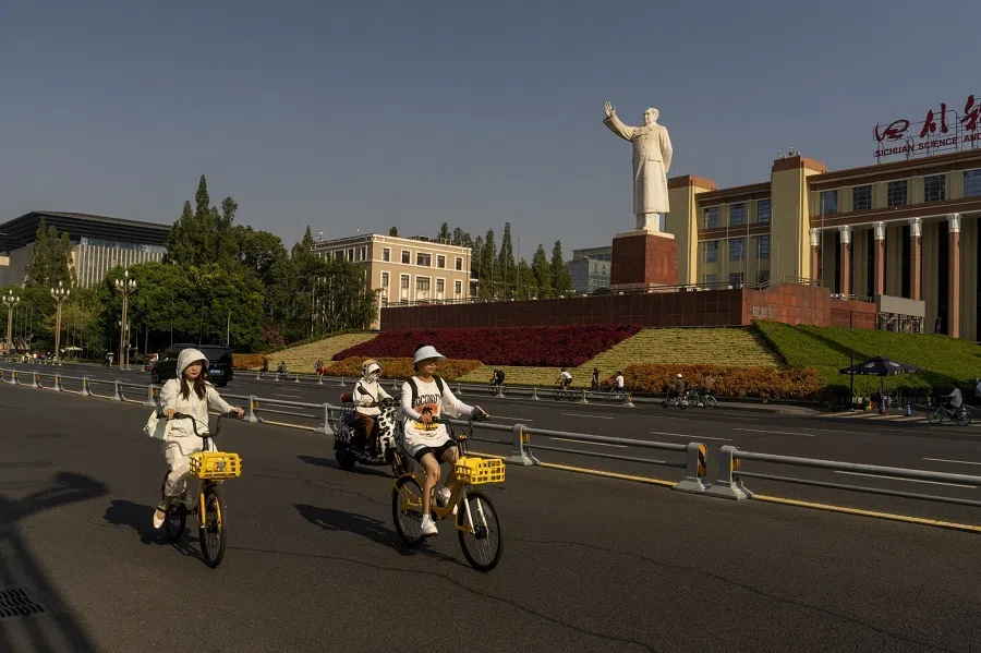 Cyclists ride past a statue of former Chinese leader Mao Zedong in Chengdu, China, on 19 August 2024. (Raul Ariano/Bloomberg)