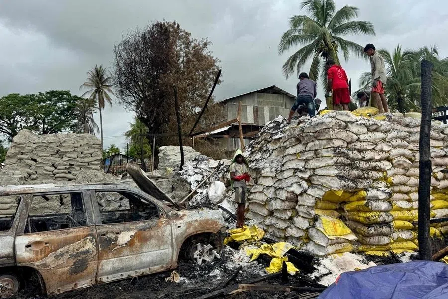 People clear debris after an airstrike by Myanmar's military in Kyauktaw, western Rakhine State on 18 June 2026.