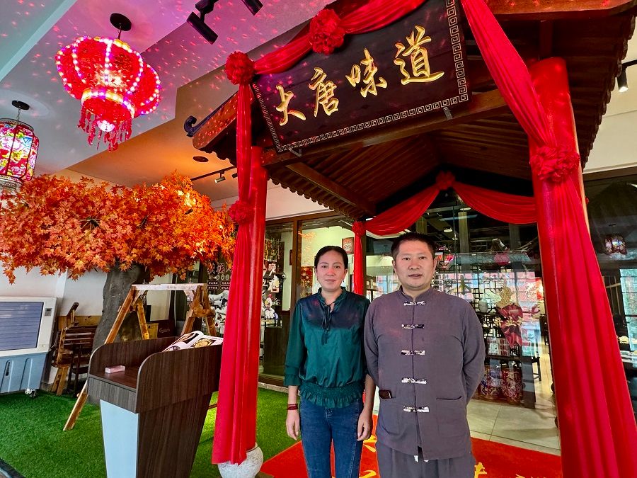 Da Tang Wei Dao, a restaurant known for its Northeastern Chinese cuisine, set up a branch at Sunway Velocity Mall last year. Owner Li Jianpeng is pictured here with his wife in front of the restaurant.