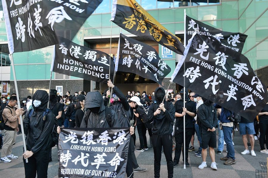 People with flags bearing Hong Kong independence slogans march in support of Save12, the campaign to save twelve Hong Kong pro-democracy activists who on August 23 were caught by mainland Chinese authorities trying to flee Hong Kong to Taiwan by boat, in central Taipei on 25 October 2020. (Chris Stowers/AFP)
