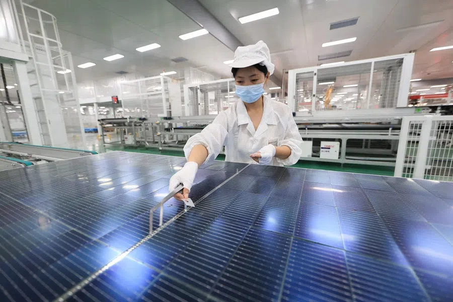 An employee works on photovoltaic cell modules, used in solar panels, at a factory in Lianyungang, in China’s eastern Jiangsu province on 26 September 2025. (AFP)