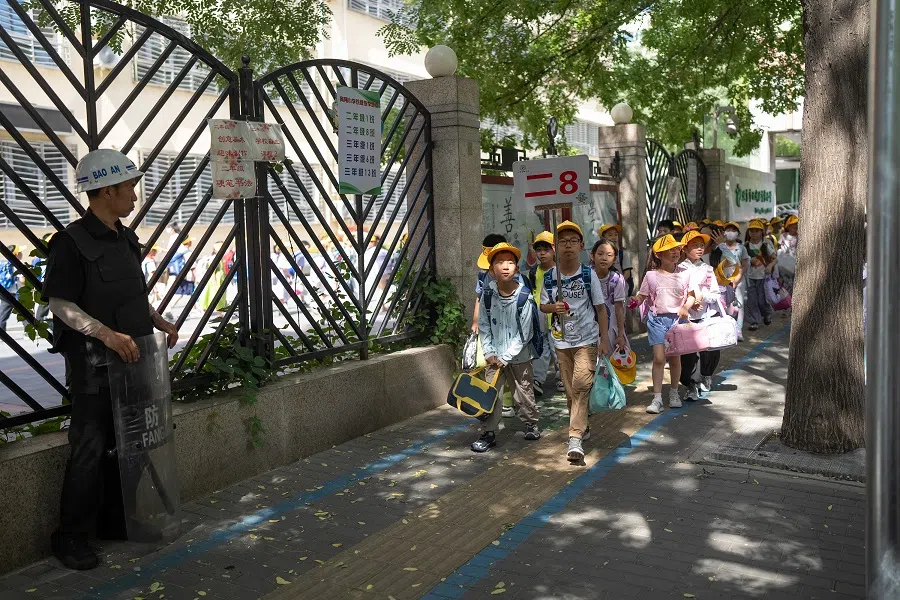 Zhuangzhuang and his classmates walking out of school. Zhuangzhuang is in the second grade and finishes school at 3pm. Except for Monday, he has dance classes after school every day.