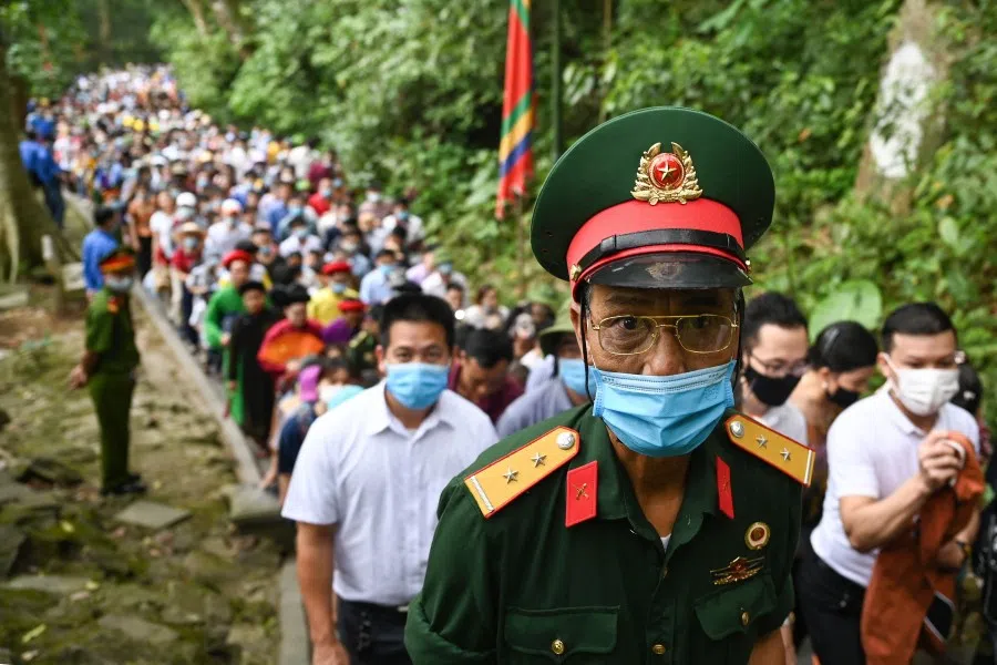 A man walks to the temple atop the Nghia Linh mountain during the Hung Kings festival in Phu Tho province on 21 April 2021 to pay tribute to the Hung Kings - the nation's traditional founders and the first kings. (Manan Vatsayayana/AFP)
