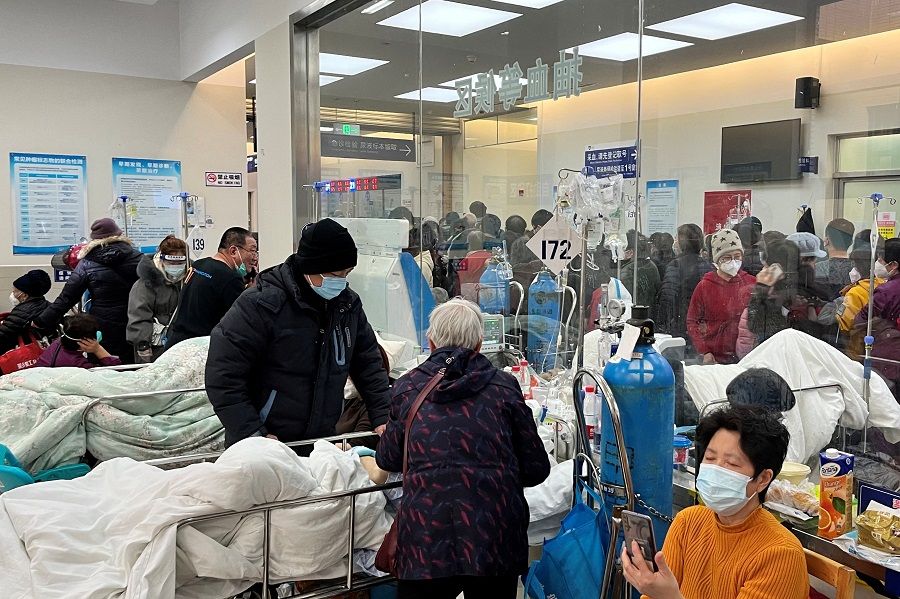 Patients lie on beds in a waiting area in the emergency department of Zhongshan Hospital, amid the Covid-19 outbreak in Shanghai, China, 3 January 2023. (Staff/Reuters)