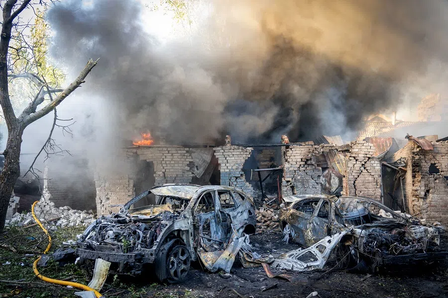 This handout photograph taken and released by the Zaporizhzhia Regional Military Administration on 29 September 2024 shows burnt-out cars next to a burning building following a missile attack in Zaporizhzhia, amid the Russian invasion of Ukraine. (Handout/Zaporizhzhia Regional Military Administration/AFP)