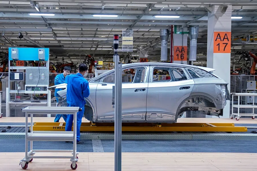 Employees work on assembly line during a construction completion event of SAIC Volkswagen MEB electric vehicle plant in Shanghai, China, 8 November 2019. (Aly Song/Reuters)