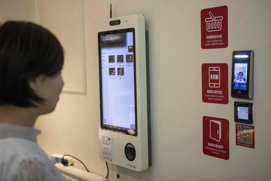 A woman using a facial recognition device installed at an IFuree Go self-service supermarket in Tianjin, August 2019. China's government has thrown its support behind companies that develop facial recognition and artificial intelligence for commerce and security, part of a drive to become a world leader in advanced technologies. (Nicolas Asfouri/AFP)