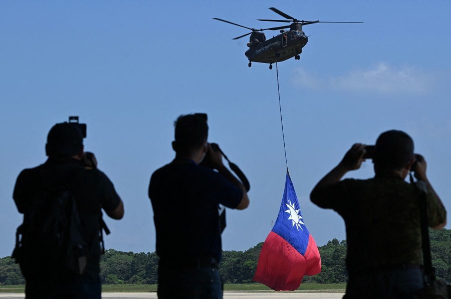 A US-made CH-47 helicopter flies an 18-metre by 12-metre Taiwan flag at a military base in Taoyuan, Taiwan, on 28 September 28, 2021. (Sam Yeh/AFP)