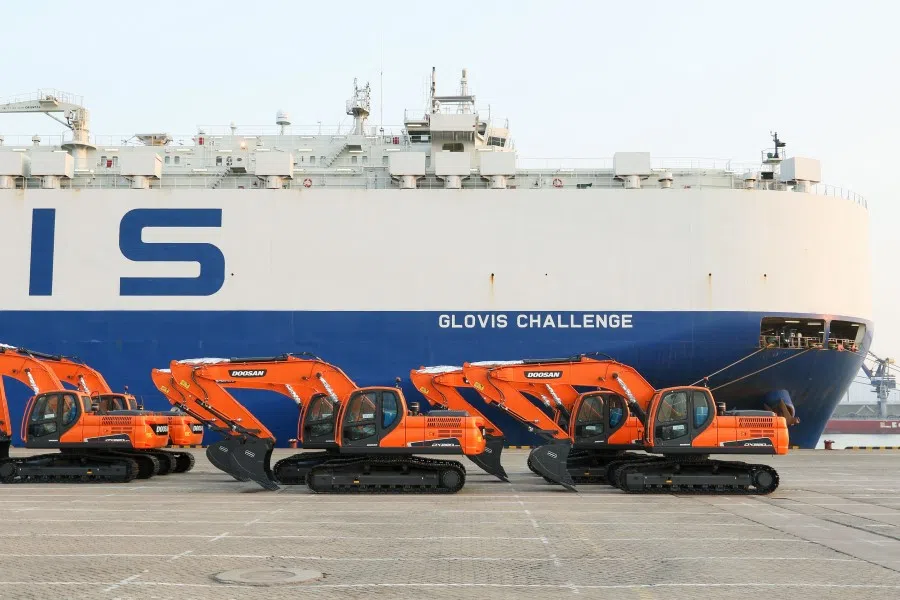 Construction vehicles to be exported wait to be loaded on a cargo ship at a port in Yantai in China's eastern Shandong province, 28 April 2020. (STR/AFP)