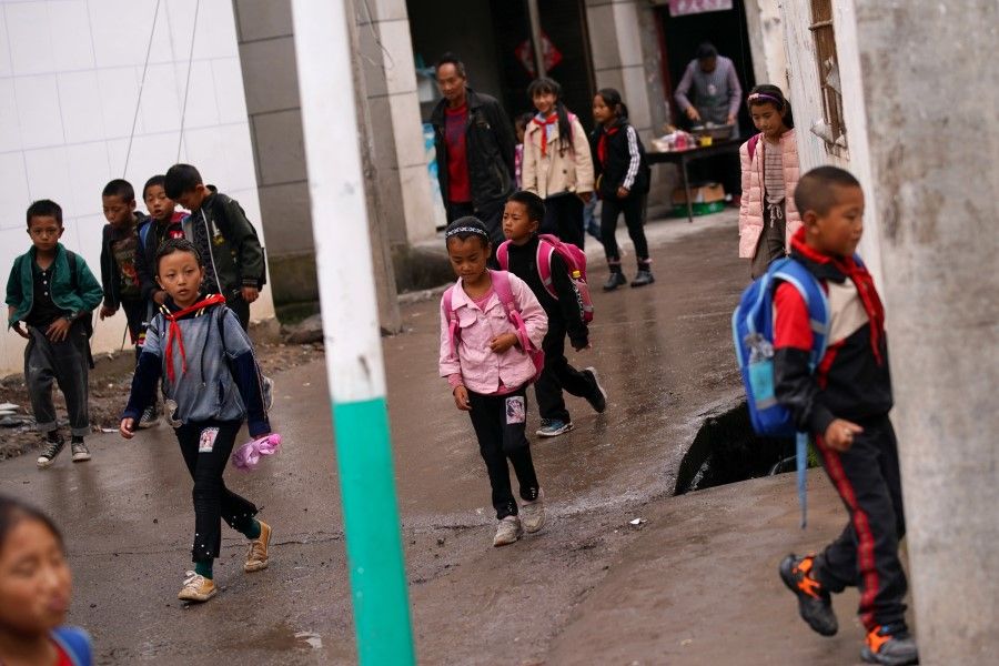 Children carrying backpacks in Yuexi county, Liangshan Yi Autonomous Prefecture, Sichuan province, China, 11 September 2020. (Tingshu Wang/Reuters)