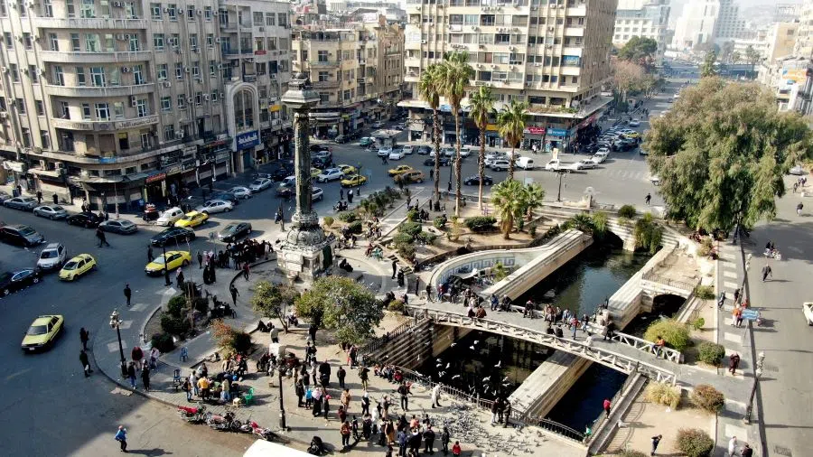 A drone view shows people and vehicles on the street in Damascus, Syria, after Syrian rebels ousted President Bashar al-Assad, on 10 December 2024. (Mahmoud Hassano/Reuters)